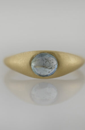 Flush set sapphire cabochon in a signet-style tapered band with a sandblast finish. Exclusively designed and handcrafted in-house, in Portland, Oregon.